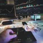 A modern trading desk with screens showing market charts and euro notes, capturing a trading atmosphere.