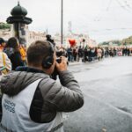 Photographer takes shots at a bustling city marathon event.