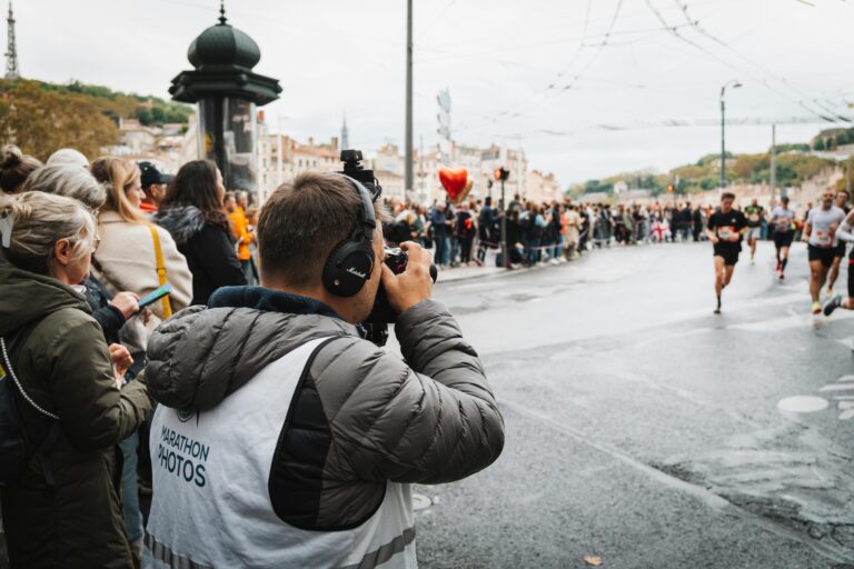 Photographer takes shots at a bustling city marathon event.