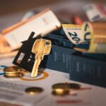 Close-up of house keys, euro bills, and charts symbolizing real estate investment and finance.