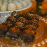 Close-up of chocolate brigadeiros on a crystal plate, perfect for desserts.
