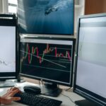 A multi-monitor stock trading setup showcasing charts and data analysis in a home office setting.