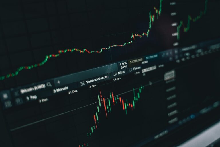 Close-up of a digital market analysis display showing Bitcoin and cryptocurrency price trends.