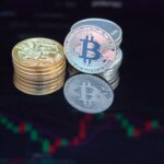 Close-up of bitcoin coins reflecting on a screen with financial market data, highlighting digital currency trend.